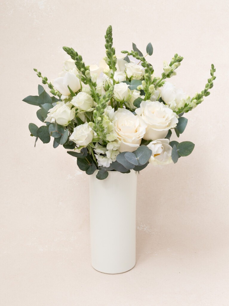 Paulette 21-stem bouquet with white roses, snapdragons, and eucalyptus. A refined floral gift for weddings, baby showers, or elegant celebrations.